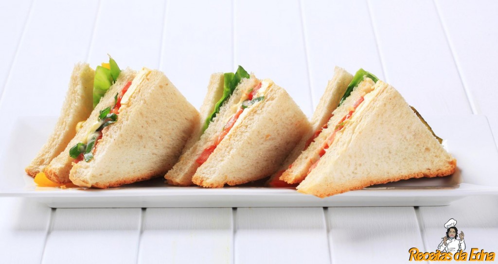 Vegetable sandwich triangles on cutting board